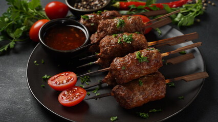 Shish kebab is a popular meal of skewered and grilled cubes of meat. Roasted Beef Kebab on a wooden...