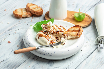 burrata. fresh handmade soft Italian cheese, white balls of burrata or burratina cheese Basil and Olive Oil and Ciabatta. place for text, top view