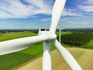 Close up aerial view of a wind turbine in a small rural wind farm in the English countryside