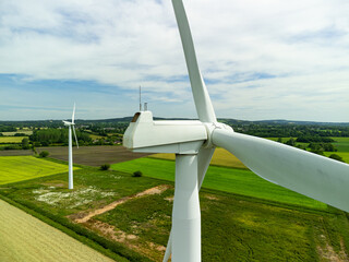 Close up aerial view of a wind turbine in a small rural wind farm in the English countryside