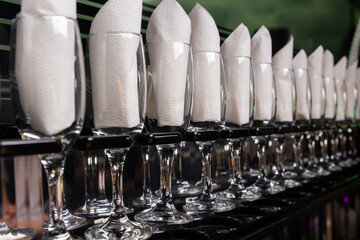 Wine glasses in the limousine with paper napkings inside.