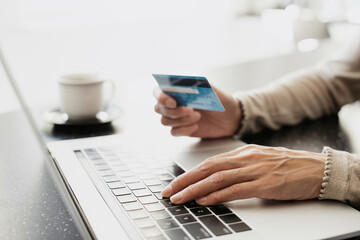 Woman using laptop computer with credit card making online order. Business, online shopping,...