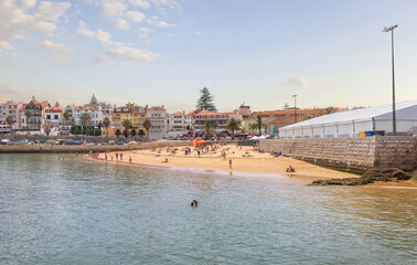 Cascais near Lisbon, seaside town. Panoramic view of beach, filled with resting people in a summer sunny day. Portugal
