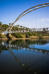 Fototapeta na wymiar Park Nahal in Hadera pedestrian bridge over the river Hadera and power station Orot Rabin