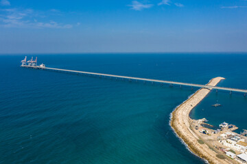 Obraz premium Big coal power station with tall chimnies and coal conductor and white steam - aerial shot in Hadera