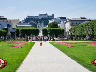 Fototapeta na wymiar Mirabell garden footpath, fountain and fortress view in Salzburg, Austria in summer