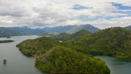 Fototapeta premium Tropical landscape: A lake surrounded by mountains and jungle. Randenigala reservoir.