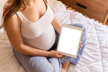 Pregnancy digital tablet mockup. Pregnant woman holding smart tablet. Mobile pregnancy online maternity application mock up. Concept of pregnancy, maternity, expectation for baby birth.