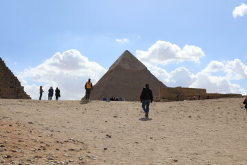 Pyramids of Giza. Scene with tourists near pyramid in Egyptian desert. Travel to the African...