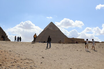 Pyramids of Giza. Scene with tourists near pyramid in Egyptian desert. Travel to the African...