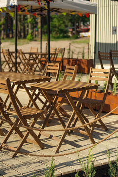 cozy summer cafe in the open air. Wooden table and chairs on the terrace