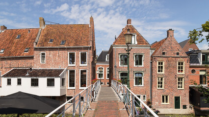 Old houses with attached kitchens above the canal in the picturesque town of Appingedam in the province of Groningen; Netherlands.