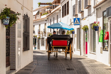 Guided tour through the picturesque streets of the Spanish mountain village of Mijas, by horse and carriage. - obrazy, fototapety, plakaty