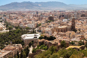 Fototapeta na wymiar Cityscape Málaga surrounded by the mountains overlooking the cathedral and the citadel of Alcazaba; Spain.
