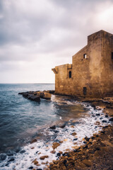 Fototapeta na wymiar East Coast of Sicily in Italy, Europe on a warm spring day at the coast with old structures