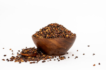 Indigofera or indigo seeds in wooden bowl isolated on white background