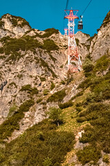 Fototapeta premium Beautiful alpine summer view with details of a cable car support at the famous Untersberg mountain, Groedig, Salzburg, Austria