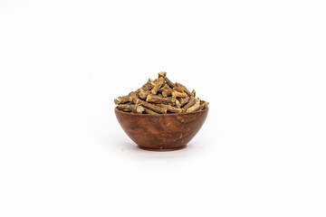 Ayurvedic herb or folk medicine Hemidesmus indicus or Nannari or Indian sarsaparilla dried roots in wooden bowl