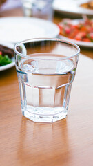 glass filled with water on the dining table