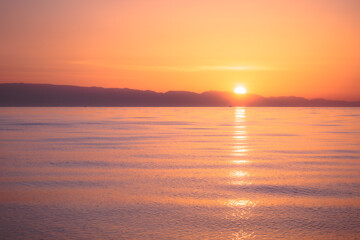 Lovely romantic warm sunrise at the Sicilian East Coast in Italy, Europe 