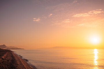 Fototapeta premium Lovely romantic warm sunrise at the Sicilian East Coast in Italy, Europe 