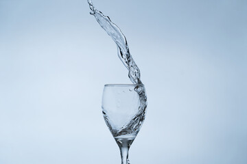 Water is jumping up from transparent glass.