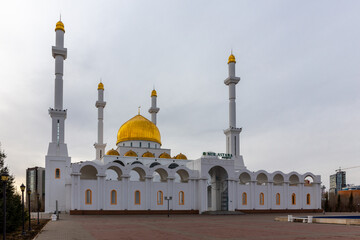 Fototapeta na wymiar Nur Sultan (Astana), Kazakhstan, 11.11.21. Nur Astana Mosque (Nur Astana Meshiti) in Nur Sultan, Kazakhstan, with white facade and golden dome and ornaments.