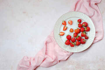 Recipes for summer holiday baking. Ripe garden strawberry in a plate. text background, sweet pastries. top view.