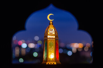 Lantern that have moon symbol on top with blurred focus of paper cut for mosque shape background....