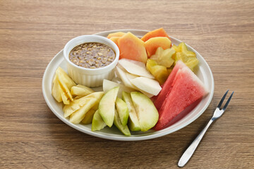 Rujak or lotis, Indonesian traditional fruit salad, made from a variety of fresh fruits and eaten with a sauce made of brown sugar, chili, salt and peanuts.
