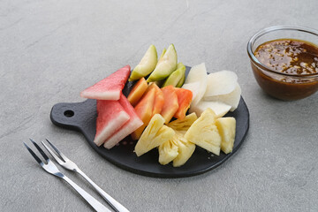 Rujak or lotis, Indonesian traditional fruit salad, made from a variety of fresh fruits and eaten with a sauce made of brown sugar, chili, salt and peanuts.
