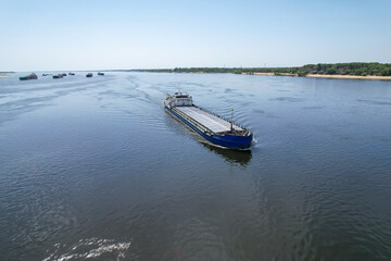 Cargo transportation. An old cargo ship on the Volga River transports grain to the port of...