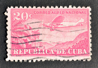 Cancelled postage stamp printed by Cuba, that shows Plane Ford 4-AT Tri-Motor over mountain...