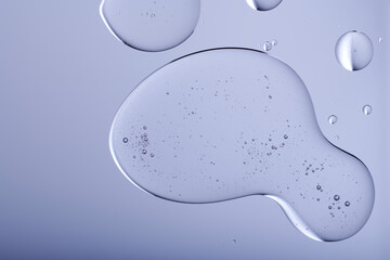 Blob with bubbles and clear formulation on a transparent background. Clear liquid with bubbles resembling glycerin, hyaluronic acid or keratin in laboratory or scientific setting.  - obrazy, fototapety, plakaty
