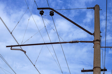 Abstract urban background - a pole and wires on a blue sky background.