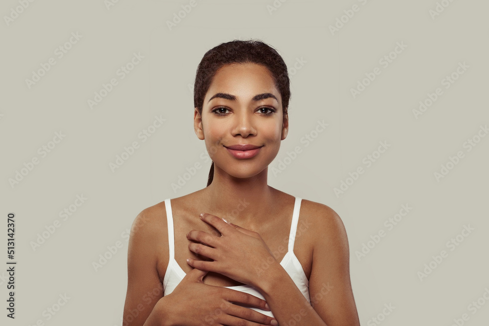 Wall mural cute young african american woman with healthy clean skin and natural makeup on white background