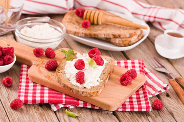 Rye bread with cottage cheese and raspberries.