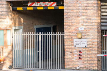 parking garage entrance with maximum height restrictions sign or signage