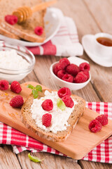 Rye bread with cottage cheese and raspberries.