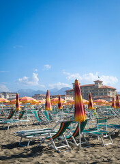 Colorful beach umbrellas and classic architecture of Viareggio, Italy with negative space for copy.