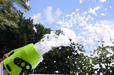 Foam making machine from plain water. Children's event in the park. Foam machine in action. Organization of children's foam parties. 