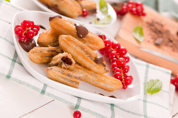 Mini churros with chocolate dipping sauce.
