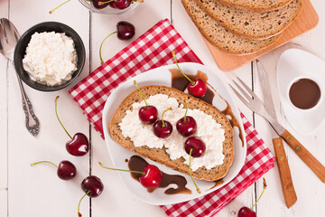 Rye bread with cottage cheese and cherries.