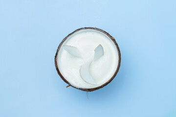 Coconut ice cream with coca chips on a blue background, top view. Coconut pleasure. Coconut meat