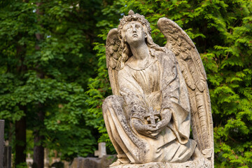 Fototapeta na wymiar Sculpture on the grave in Lychakiv Cemetery, Lviv, Ukraine.
