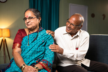 Happy elderly husband consoling wife after quarrel at home - concept of relationship, family bonding and togetherness