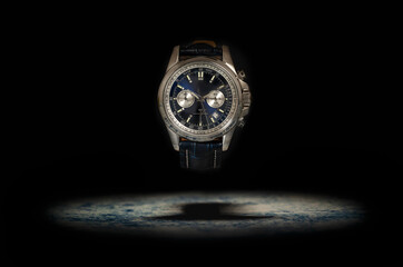 Studio shot of a blue fancy luxury unbranded Men watch on the black background. Stainless steel...