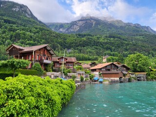 Fototapeta premium Beautiful summer landscape in Iseltwald village on shore of Lake Brienz in Canton Bern, Switzerland.