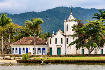 Church, forested hills and old colonial-style houses in the historic city of Paraty on the coast of Rio de Janeiro