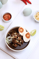 Rawon, Indonesian Beef Black Soup Dish.  Black Color Made from Keluak Nut as the Main Seasoning
